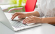 © serhii - female hands use a laptop in the office.