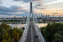 Panorama Of Warsaw In Poland With Siekierkowski Bridge Over Vistula River During Sundown.