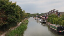 Green Canal With Bar And Barges