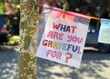 A handmade sign prompts neighbors to consider and share what they're grateful for
