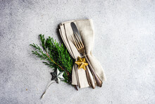 Overhead View Of Christmas Cutlery Set With Christmas Bauble Decorations And Thuja Branches