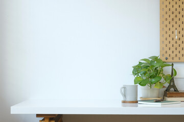 Wall Mural - Home office desk with houseplant, cup of coffee and book. Copy space for your text.