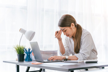 Businesswoman get stressed and headache, migraine headaches can be debilitating.