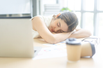 Wall Mural - Young adult business asian woman fatique and sleep on table at office