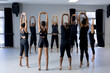 © Wavebreak Media - Group of modern dancers stretching up in circle in a studio