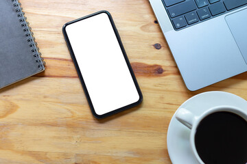 Wall Mural - Top View Work space office desk, mockup empty screen smartphone on wooden table. with clipping path, with blank space screen for advertising text.