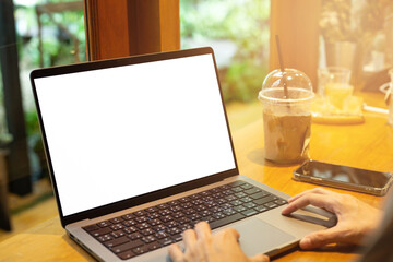 Wall Mural - mock up empty screen notebook, businesswoman working on his laptop computer with blank space screen for advertising text on wood desk in Cafe