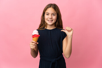 Wall Mural - Child with a cornet ice cream over isolated pink background proud and self-satisfied