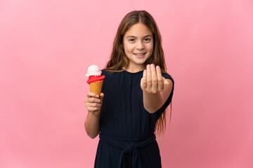 Wall Mural - Child with a cornet ice cream over isolated pink background inviting to come with hand. Happy that you came