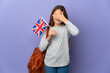 Child holding an United Kingdom flag over isolated background covering eyes by hands. Do not want to see something