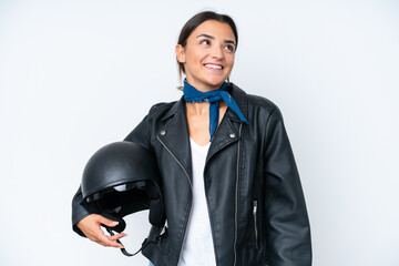 Poster - Young caucasian woman with a motorcycle helmet isolated on blue background thinking an idea while looking up