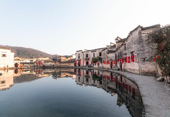 Wall Mural - Lanterns on ancient buildings near the Half moon pond in Hongcun, China