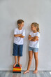 © Inna Vlasova - Cool kids, little boy and girl measure their height a