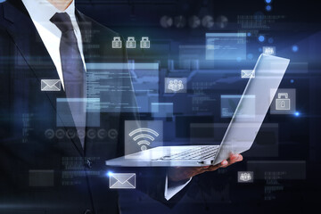 Aufkleber - Close up of businessman hand holding laptop with abstract glowing digital transformation hologram on blurry background. Double exposure.