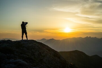 Silhouette of a photographer taking a photo of the sunset