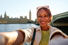 Happy Young Woman Taking Selfie In Front Of London Bridge
