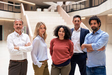 Confident Multiracial Colleagues Standing In Lobby