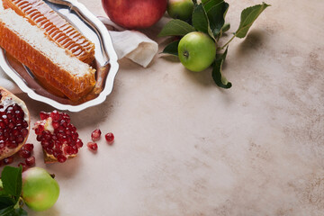 Wall Mural - Rosh Hashanah. Pomegranate, apples and honey traditional products for celebration on light beige old rustic concrete background. Jewish Autumn Rosh Hashana celebration. Jewish holiday Rosh Hashana.