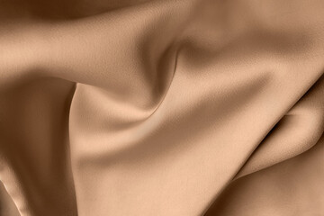 beige color or light brown creased smooth luxury satin silk cloth texture decorate background with m