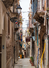 Wall Mural - Ortigia island of Siracusa (Sicilia, Italy) - A historical center view of the touristic baroque island in the municipal of Siracusa, Sicily, during the summer; UNESCO site, with castle and old church