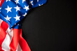 © Supagrit Ninkaesorn - Colorful American flag close up in dark background with copy space for text insert.