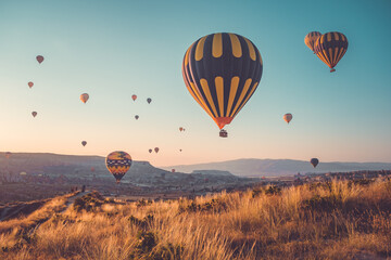 Sunrise tourists attraction on hot air balloons in Cappadocia. Sunset hill panoramic view. Best famous travel locations. Natural summer scenery, adventure concept. Colorful morning scene background