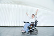 © Renata Hamuda - portrait of a happy disabled woman in a wheelchair laughing with open arms, concept of overcoming disease
