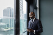 © ReeldealHD images - African American businessman using smartphone with view of city skyline
