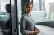 © ReeldealHD images - Portrait of African American businesswoman with city skyline view