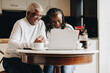 © Jacob Lund - Cheerful senior couple having a video call on a laptop