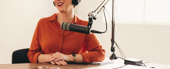 Wall Mural - Happy woman appearing as a guest on a radio show