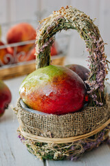 Canvas Print - Fresh ripe mango in a basket over white table