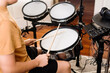 © Austockphoto - teen boy practising drums at home