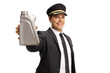 Smiling young professional chauffeur in a uniform holding a bottle of engine oil