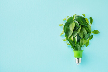 green eco friendly lightbulb from fresh leaves top view. energy saving, ecology and environment sust