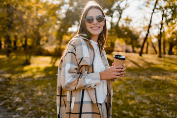 attractive young woman walking in autumn wearing jacket