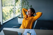 © Prostock-studio - Taking break. Relaxed african american businesswoman resting on chair, leaning back at workplace in office