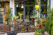 Beautiful and cozy terrace of country house decorated with lots of plants and flowers at backyard