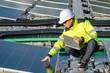© reewungjunerr - Asian engineer working at Floating solar power plant,Renewable energy,Technician and investor solar panels checking the panels at solar energy installation