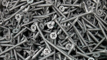 Close-up of a big pile of beautiful grey screws