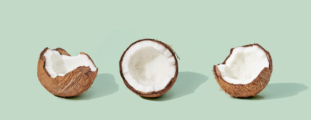 Wall Mural - Coconut on green background. Food concept.