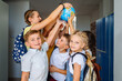 © Iryna - Different age team of children playing with globe in hallway at school. . Education, ecology, creativity and logical thinking concept.