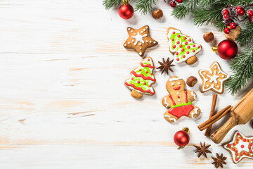 Wall Mural - Christmas gingerbread with decorations on white wooden table. Christmas baking. Top view with copy space.