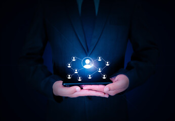 Poster - Networking Concept Background with Connecting signs hovering over mobile in hand. Businessman holding smartphone with networking concept