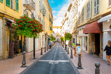 A Picturesque Street Through The Old Town Center Of Antibes, France, In The Cote D'Azur, French Riviera Region Along The Mediterranean Sea.