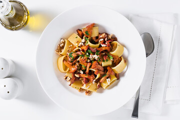 pasta with chanterelle mushrooms in a plate on the table