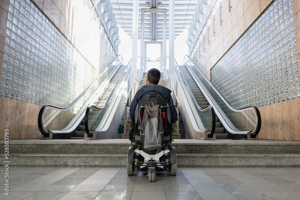 Person with disability on electric wheelchair stopping at the bottom of ...