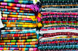 colorful scarfs pile at ecuadorian handcraft market