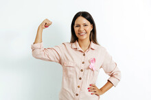 Young Brazilian Woman With Breast Cancer Ribbon Over White Background