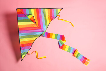 Wall Mural - Bright rainbow kite on pink background, top view